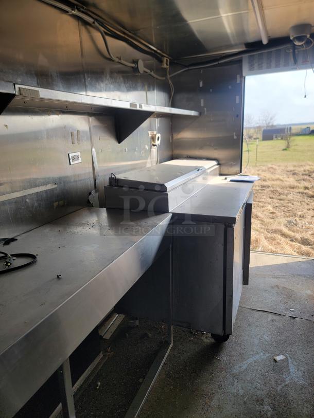 2019 Quality Cargo 24' mobile ghost kitchen interior with stainless steel counters and shelving. Needs cleaning and exterior TLC.