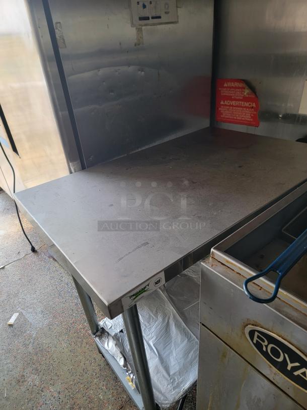 Quality Cargo 24' mobile kitchen interior with stainless steel prep table and appliances. Needs cleaning and exterior TLC.