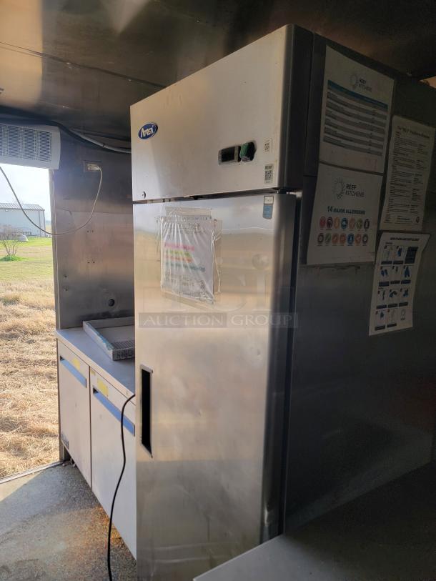 24' Quality Cargo mobile ghost kitchen interior with stainless steel fridge, storage, and HVAC. Needs interior cleaning.