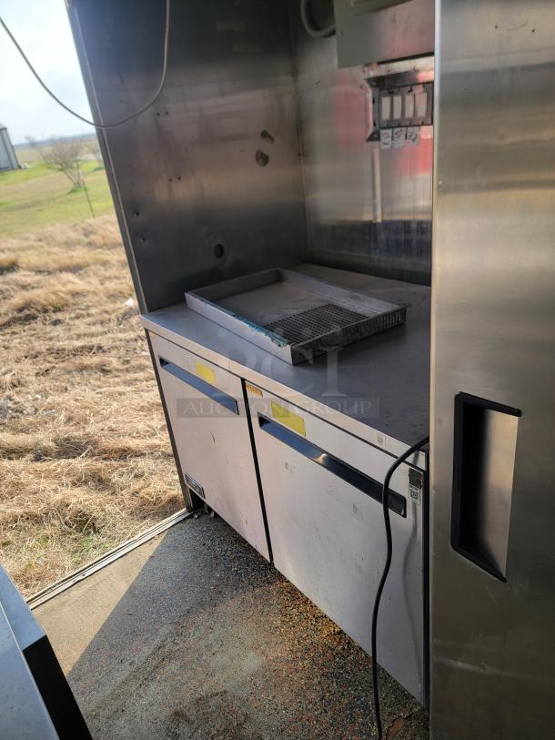 24' Mobile Ghost Kitchen interior with stainless steel prep area, Garland 4-burner range, needs cleaning, 2019 Quality Cargo.