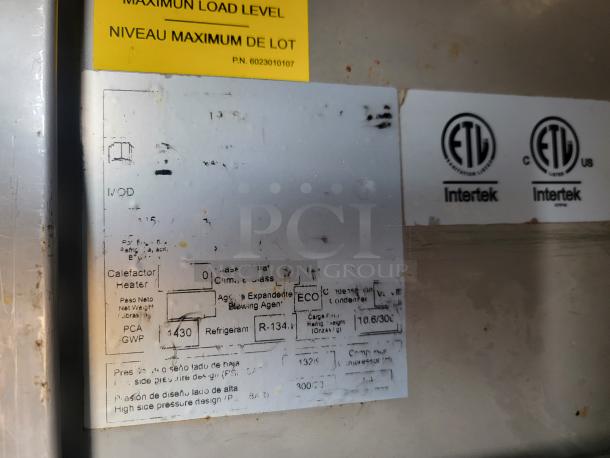 Label with ETL Intertek certification marks, model, refrigerant type R-134, and maximum load details visible.