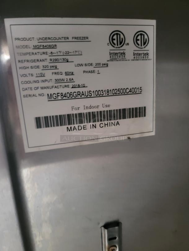 Undercounter freezer label showing model MGF8406GR, temperature range -8° to -1°F, and refrigerant R290/130g.