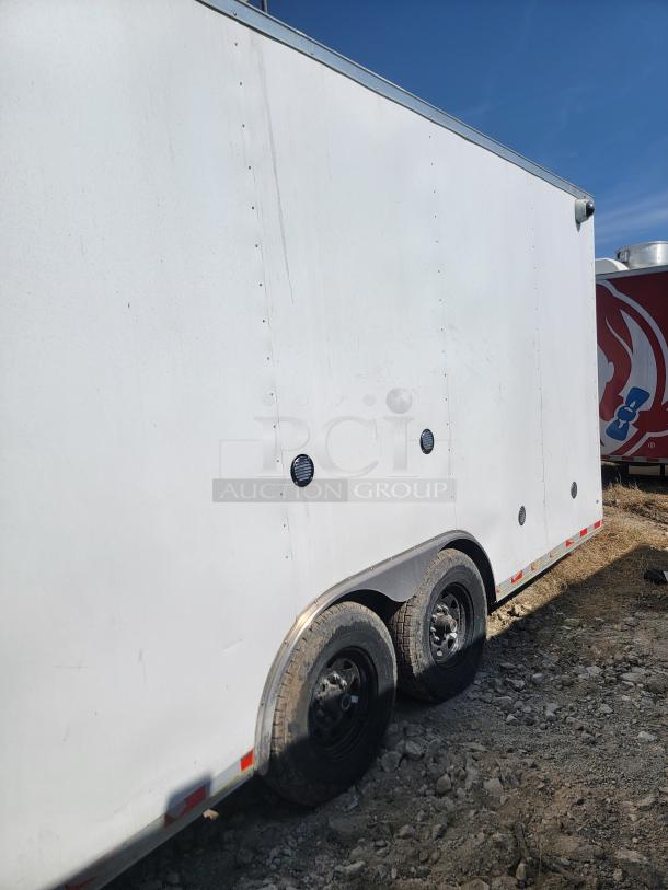 2021 Diamond Cargo 24' mobile kitchen trailer, white exterior, dual axles, minor exterior wear, ideal for heavy commercial use.