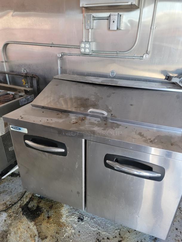 2021 Diamond Cargo 24' mobile kitchen interior with Nor-Lake Advantage refrigeration, showing stainless steel surfaces and dual doors.