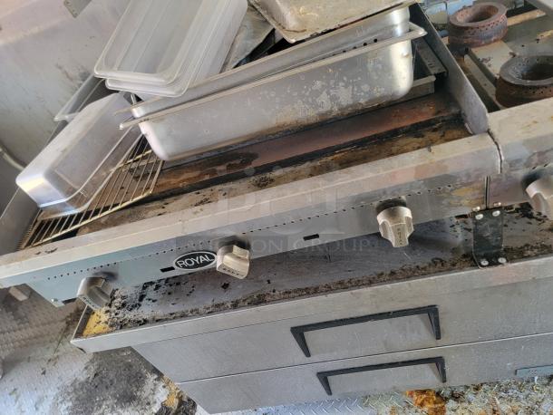 Royal cooking suite in 2021 Diamond Cargo mobile kitchen, featuring a gas range and storage drawers. Needs cleaning.