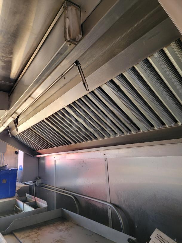 2021 Diamond Cargo 24' mobile kitchen interior, featuring a stainless steel Southbend cooking line and ventilation system.