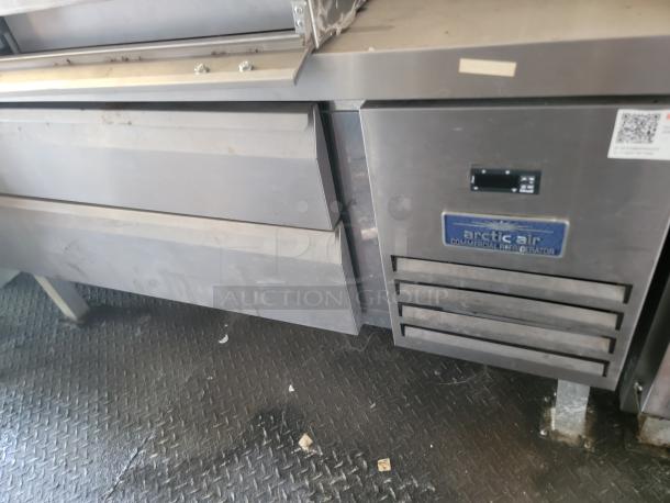 2021 Diamond Cargo 24' mobile kitchen with Arctic Air commercial refrigerator, stainless steel finish, and secure flooring.