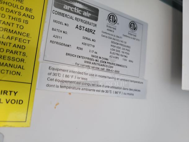Arctic Air commercial refrigerator label, model AST48RZ, uses refrigerant R290, 115V, 4.3 amps, 60Hz, made in China.