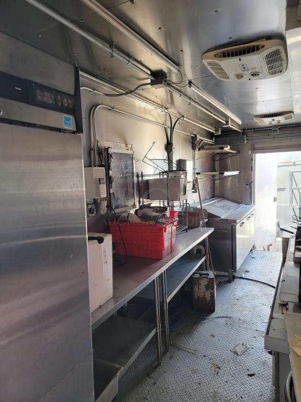 2021 Diamond Cargo mobile kitchen interior, featuring stainless steel surfaces, CaptiveAire ventilation, and Ansul Fire Suppression system. Clean condition.