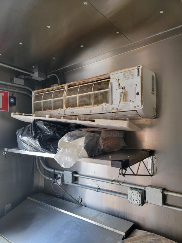 2021 Diamond Cargo mobile kitchen interior showing Mirage Ventus X Mini Split, shelving, and electrical outlets.