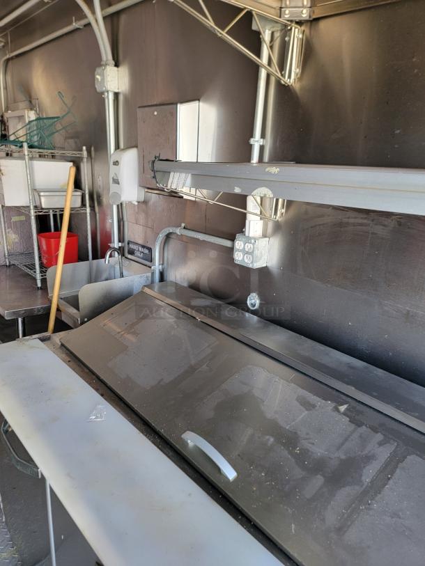 2021 Diamond Cargo 24’ mobile kitchen interior, featuring prep area, industrial ventilation, and fire suppression system.