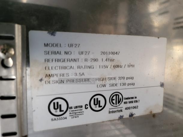 Label showing refrigeration specs: Model UF27, Serial UF27-20110047, R-290 refrigerant, 115V, 3.5A, design pressure 320/130 psig.