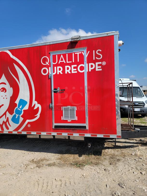2021 Rock Solid Cargo 28' mobile kitchen with bold red graphics. Features include ventilation hood, triple axles, and door vent.