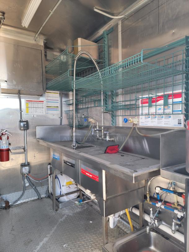 2021 Rock Solid Cargo 28’ mobile kitchen interior with Ecolab SmartPower™ station, 3-compartment sink, ventilation hood.