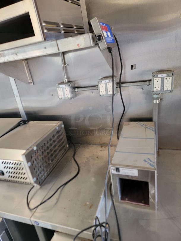 Interior of 2021 Rock Solid Cargo 28' mobile kitchen showing stainless steel counters, power outlets, and equipment stations.