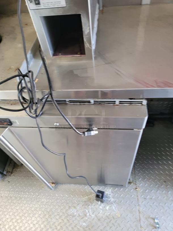 2021 Rock Solid Cargo 28' mobile kitchen interior, featuring stainless steel counters, cables, and diamond plate flooring.