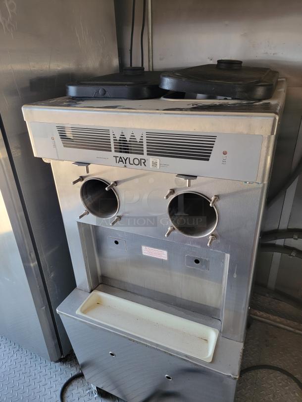 Industrial Taylor soft serve machine inside 2021 Rock Solid Cargo mobile kitchen. Featuring dual dispensers and stainless steel design.
