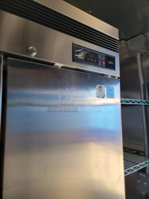 Stainless steel commercial refrigerator inside 2021 Rock Solid Cargo 28' mobile kitchen, temperature control panel visible.
