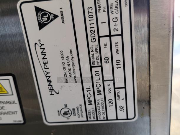 Label on Henny Penny appliance showing UL certification, model MPC-1L, 120 volts, 110 watts, and serial number GD2111073.