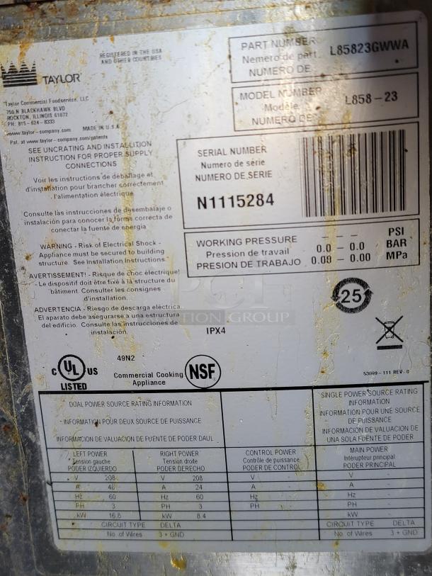 Label on a commercial cooking appliance showing power source ratings, model L858-23, part L85823GWWA, and serial N1115284.