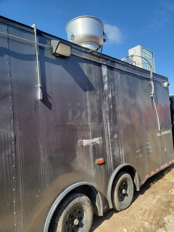 2020 Diamond Cargo 28' food trailer, black exterior, dual axle, roof vent, signs of weather exposure.