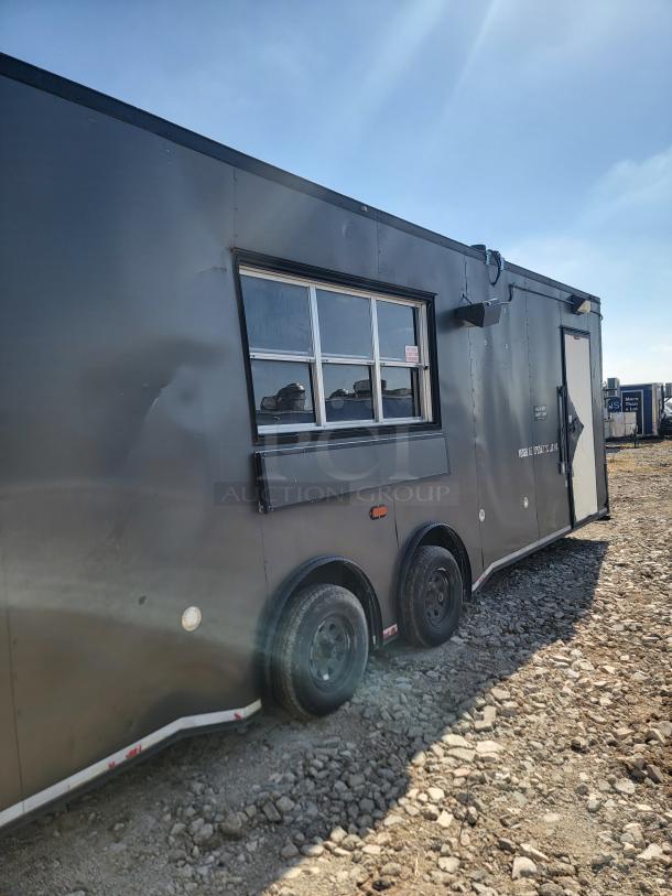 2020 Diamond Cargo 28' food trailer with dual axle, black exterior, and service window. Equipped for high-volume cooking.