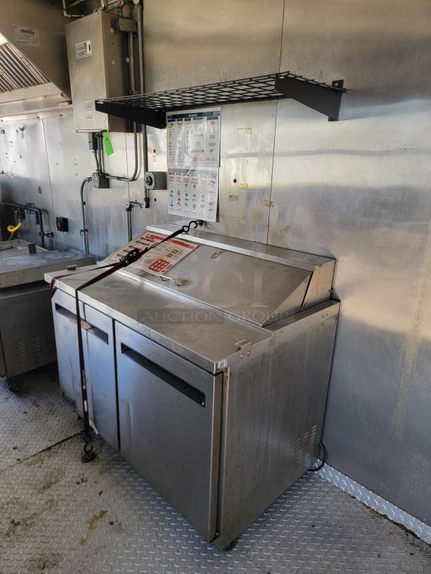 28' Diamond Cargo food trailer interior with professional Black Diamond cooking equipment and Arctic Air refrigeration, shown in good condition.