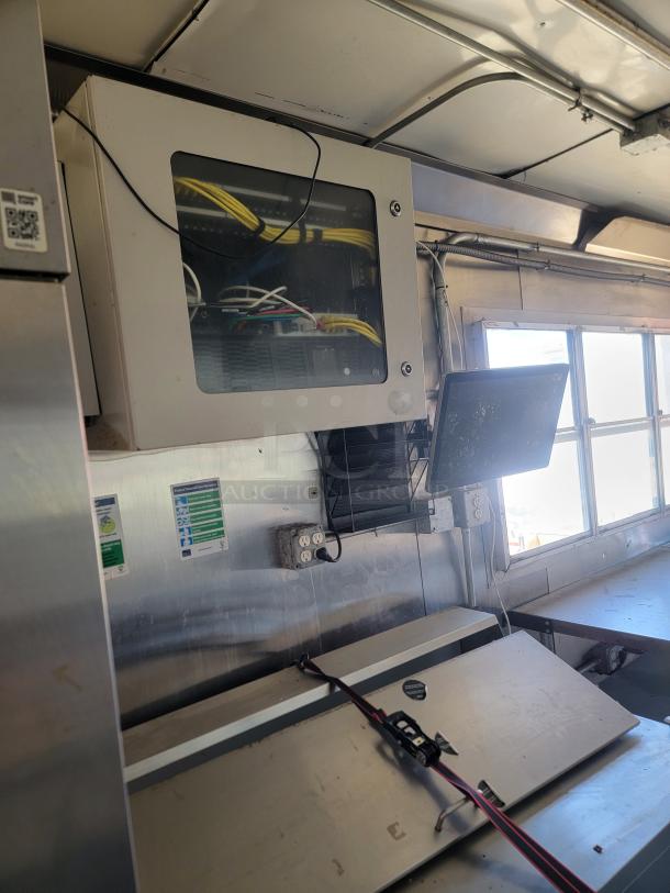 Interior of a 2020 Diamond Cargo 28' food trailer with stainless steel surfaces, electrical outlets, and network cables.