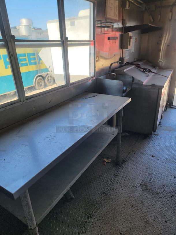 2020 Diamond Cargo 28' food trailer interior. Features metal counters, industrial flooring, and Arctic Air refrigeration.