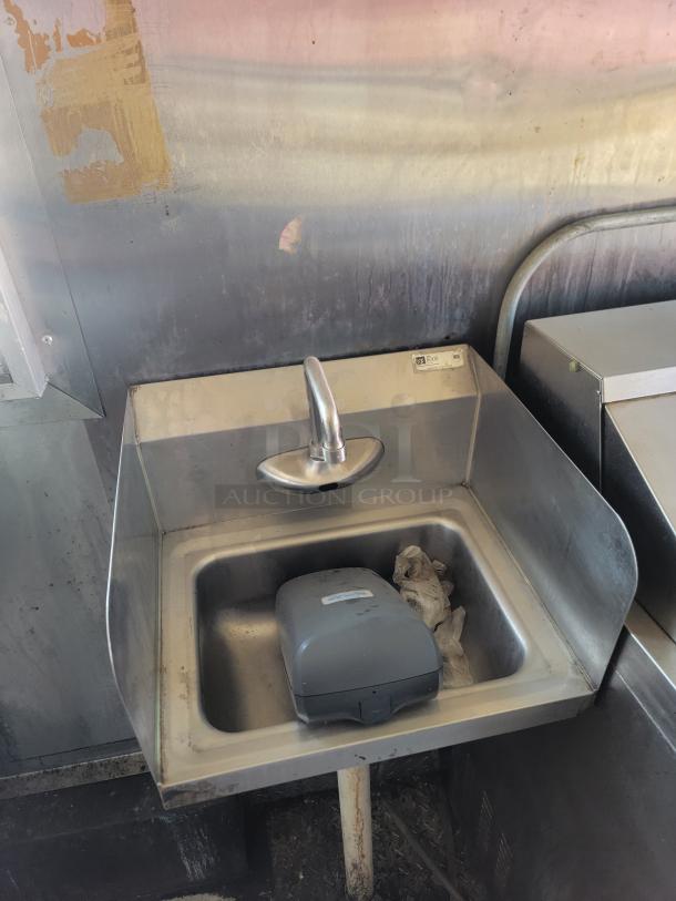 Stainless steel sink inside 2020 Diamond Cargo food trailer, with faucet, soap dispenser, and visible stains on backsplash.