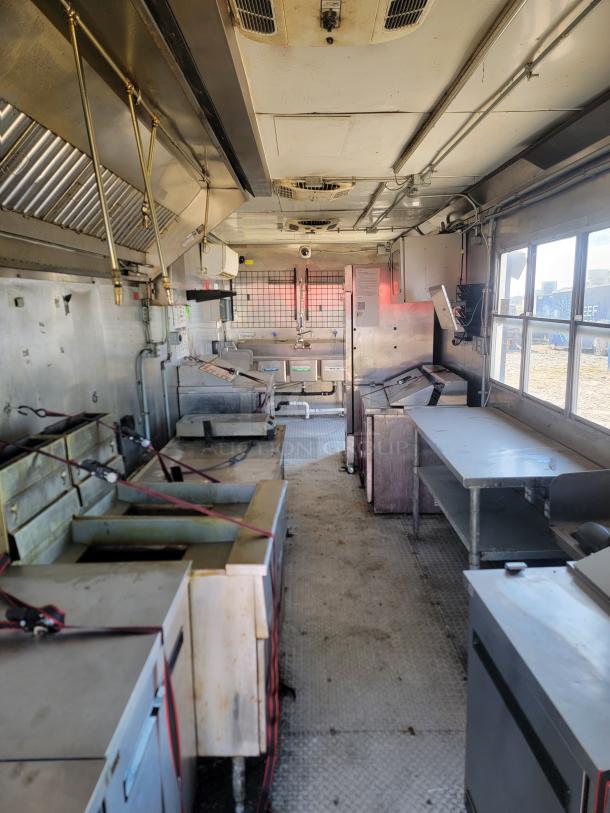 Interior of a 2020 Diamond Cargo 28' professional food trailer. Equipped with Black Diamond cooking gear, Arctic Air fridge, Mitsubishi climate control, and dual axle setup.