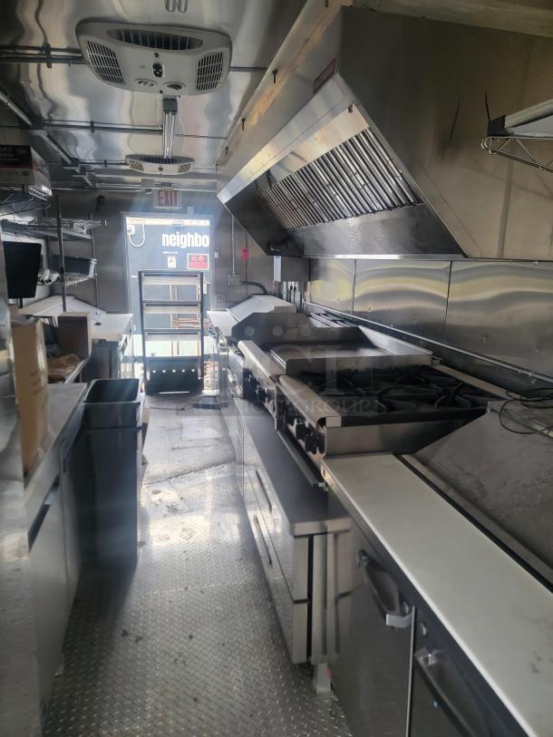 2021 Rock Solid Cargo 8.5' x 24' food trailer interior, featuring Imperial fryers, Wells griddle, CaptiveAire hood.