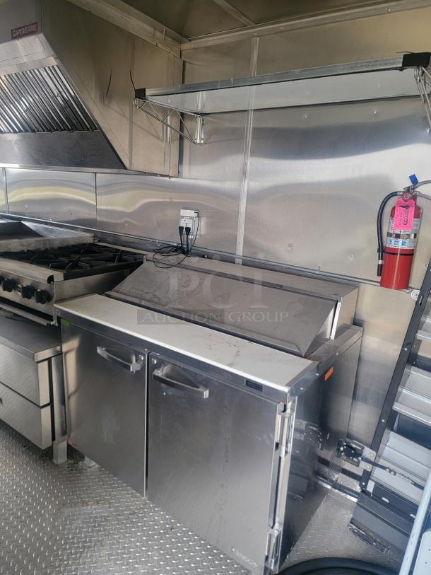 2021 Rock Solid Cargo 8.5' x 24' food trailer interior; features Imperial fryers, Wells griddle, CaptiveAire hood.