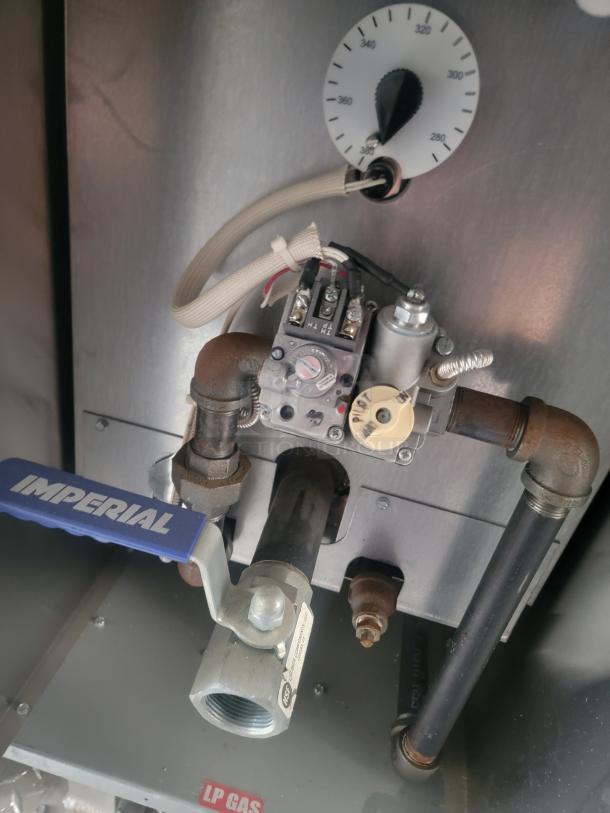 Close-up of Imperial fryer control in a Rock Solid Cargo food trailer, featuring LP gas connection and temperature gauge.