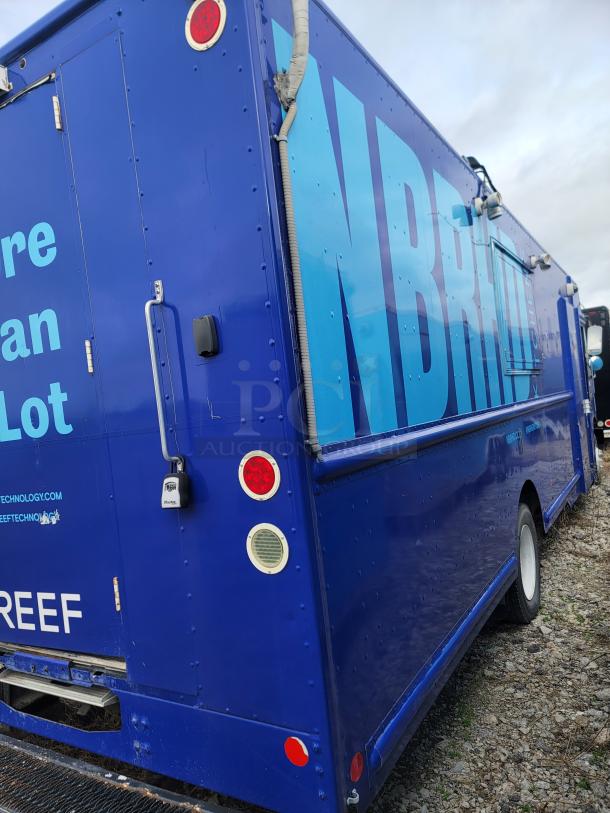 Blue delivery truck with large "NBR" and "REEF" branding. Handles and rear lights visible. Good exterior condition.