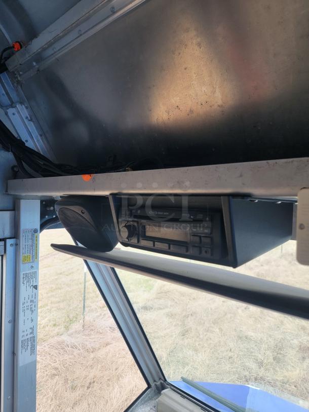 Vehicle interior showing overhead storage with a Blaupunkt stereo system, visible buttons, and side speaker. Tags list specifications.