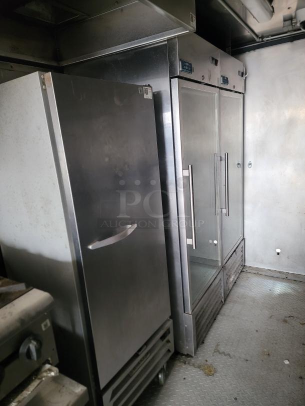 Commercial kitchen refrigerators, stainless steel finish, dual glass door model, some wear, visible labels and handles.