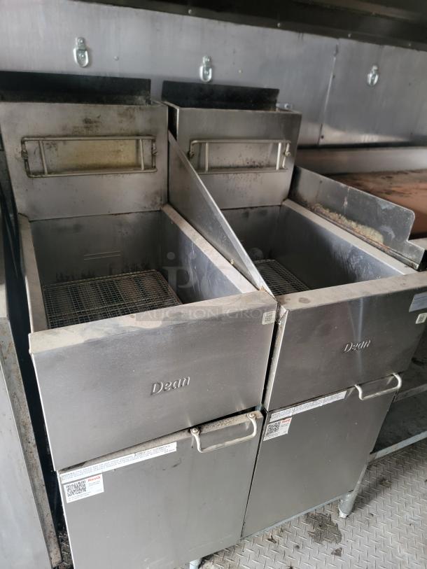 Two Dean commercial deep fryers with visible wear, stainless steel finish, and control labels. Ideal for restaurant use.