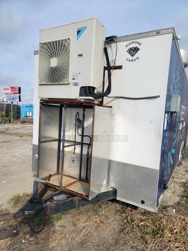Daikin AC unit on a Diamond Cargo trailer, outdoor placement. Visible rust on metal parts, indicating use in rugged conditions.