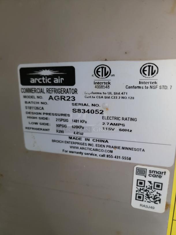 Label of Arctic Air AGR23 commercial refrigerator showing model, serial number S834052, design pressures, and electrical specifications.