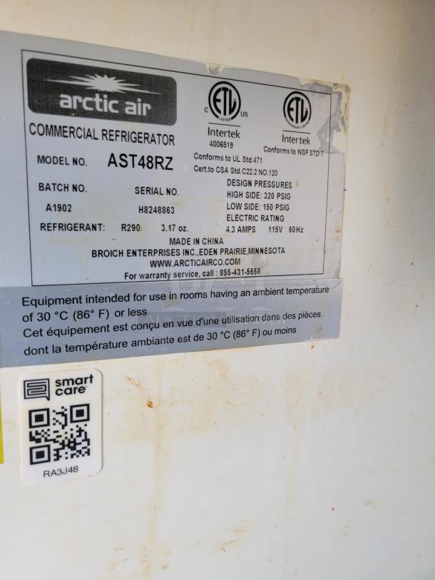 Arctic Air Commercial Refrigerator AST48RZ label; details model, batch, serial number, refrigerant, pressure, and voltage.