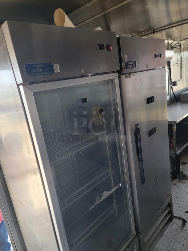 Arctic Air commercial refrigerator and freezer. Stainless steel, dual units. Visible scratches and wear, model tags intact.