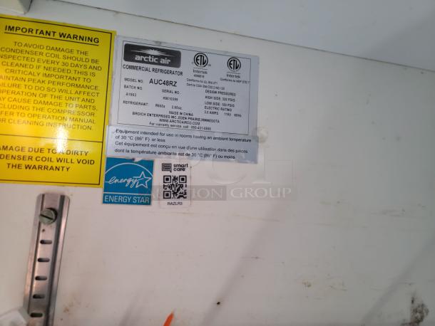 Arctic Air commercial refrigerator model AUC48R2, with Energy Star label, featuring inspection and safety instructions.