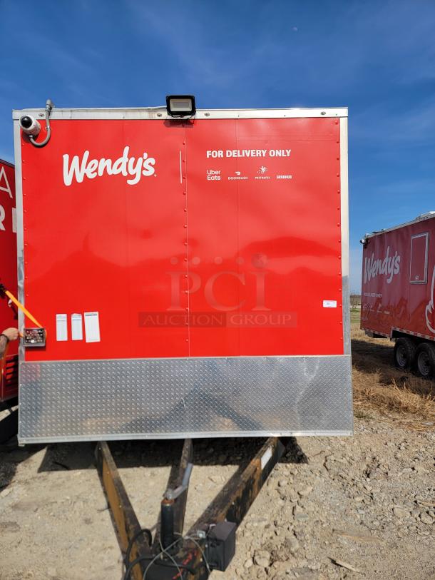 Red Wendy's delivery trailer with logo and delivery service logos. Exterior in good condition with visible security camera and hitch.