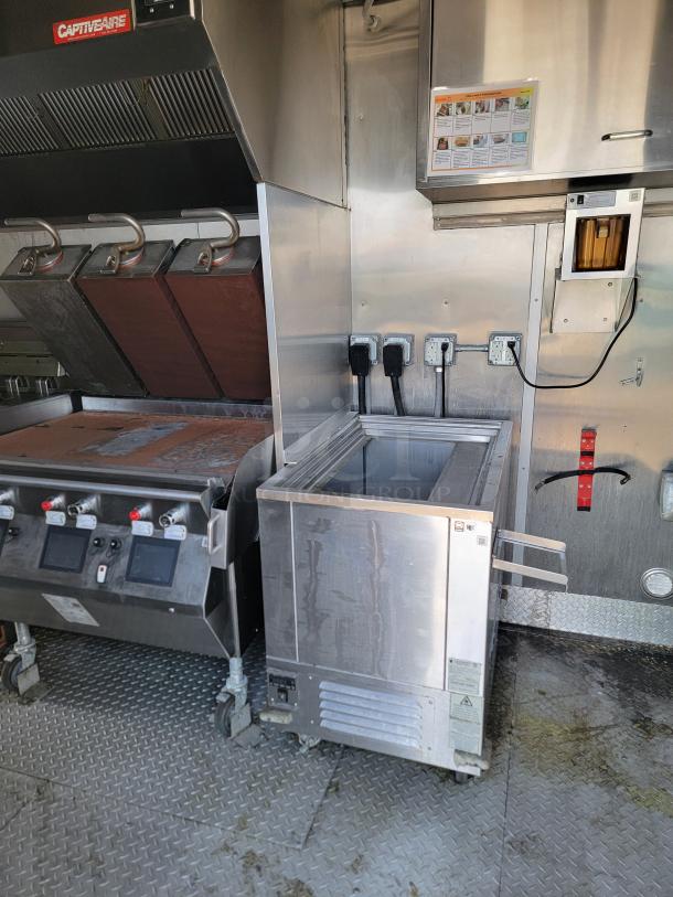 Stainless steel commercial deep fryer, CaptiveAire brand, with control panel and power sockets. Good condition.