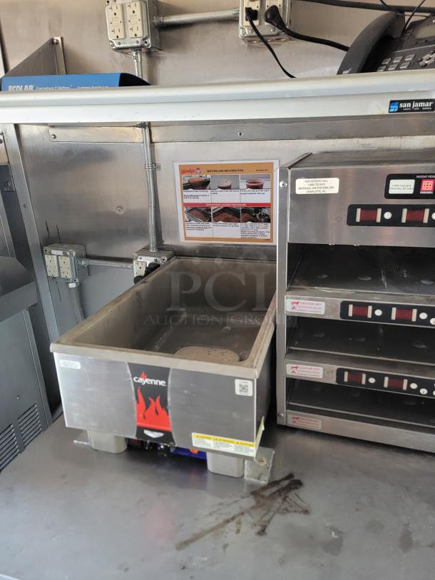 Cayenne countertop food warmer with stainless steel finish, used condition. Visible label indicates model information.