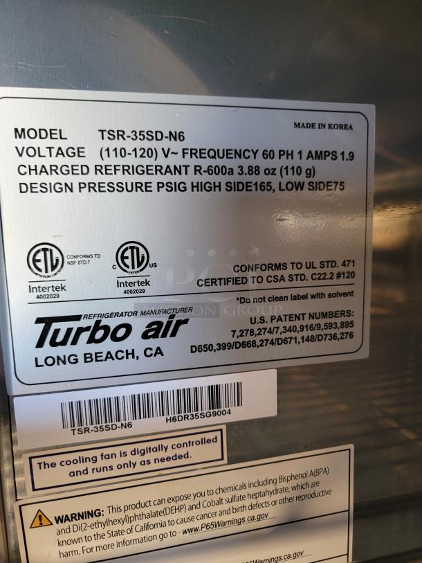 Turbo Air refrigerator model TSR-35SD-N6, made in Korea. Key specs: 110-120V, 1.9 Amps, R-600a refrigerant. Safety and warning labels visible.