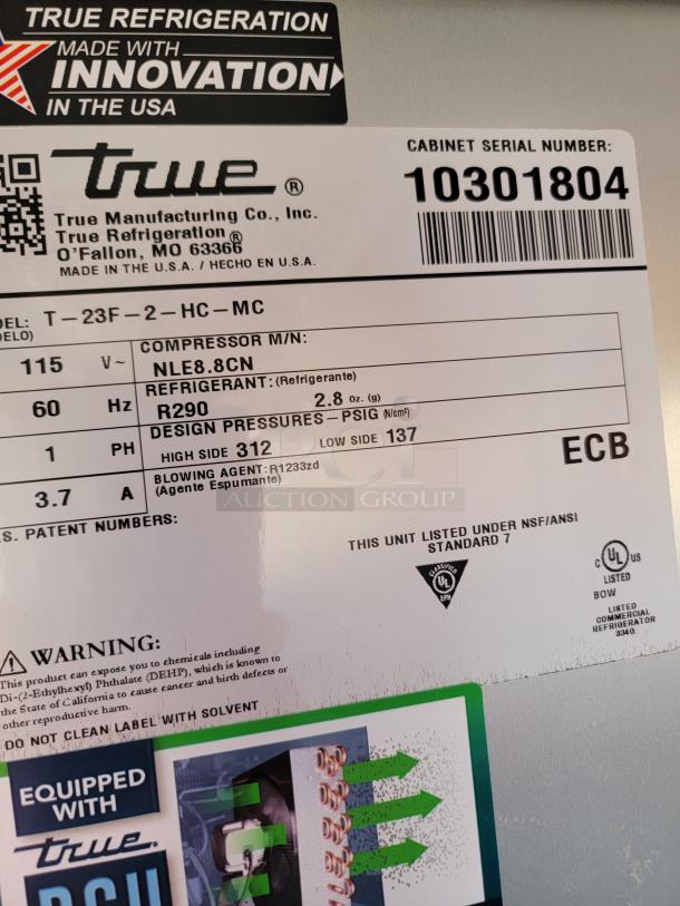 True Refrigeration T-23F-2-HC-MC label showing specifications: 115V, 60Hz, refrigerant R290, compressor NLE8.8CN, cabinet serial number 10301804.
