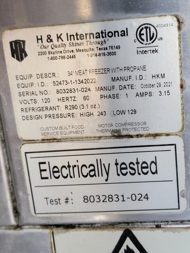 Tag on H & K International 34" meat freezer with propane. Serial: 8032831-024, Manuf. Date: Oct 29, 2021. Electrically tested.