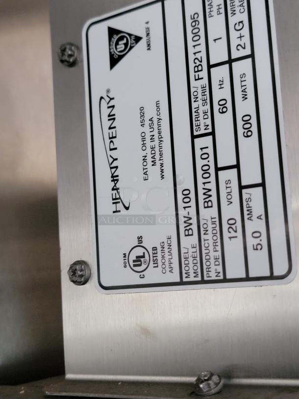 Henny Penny BW-100 appliance label showing model number, serial number FB2110095, 120 volts, 600 watts, UL listed.